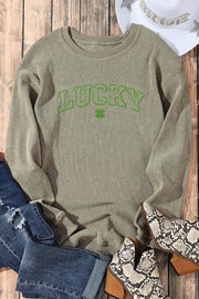 Light green ribbed crewneck sweatshirt with "LUCKY" graphic and shamrock detail.