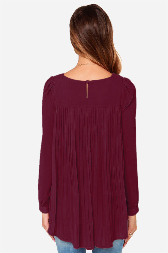 Burgundy long sleeve blouse with pleated backline and button closure.