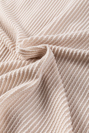 Tan textured knit fabric with white ribbed stripes, showing material detail.
