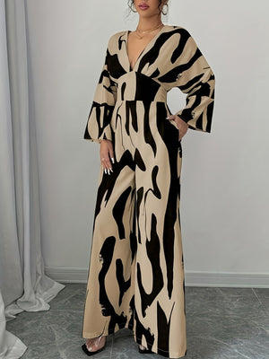 Women's abstract print wide leg jumpsuit with V-neck and bell sleeves.