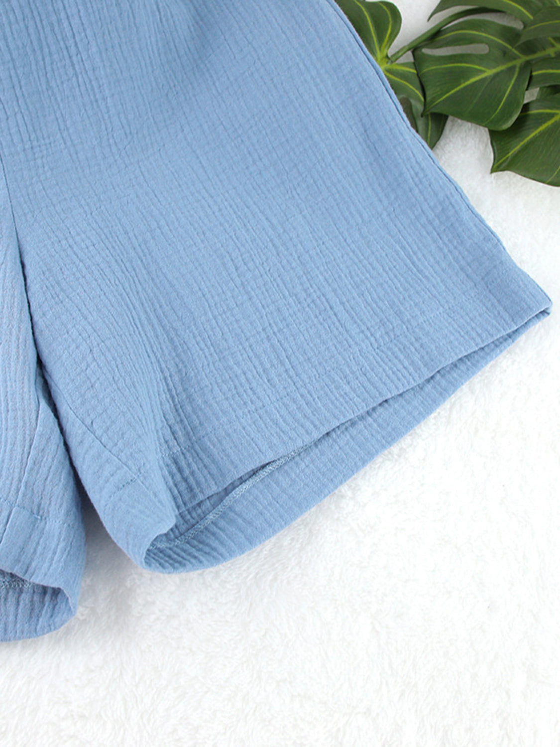 Light blue textured cotton bermuda shorts with a casual, breathable cut.