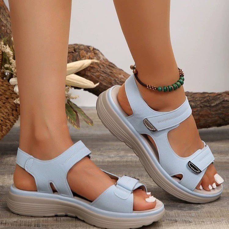 Sky blue adjustable open-toe sandals with contrast stitching and hook-and-loop straps.
