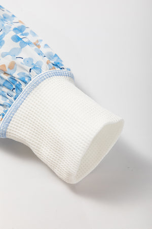 White waffle knit sleeve detail on a floral print blouse