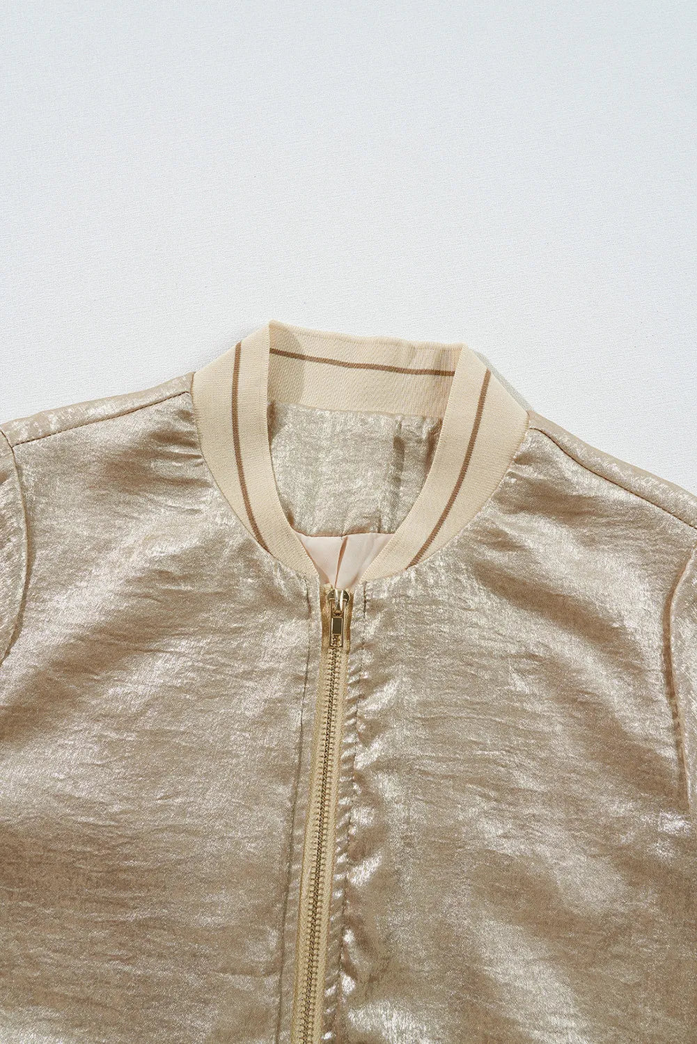 Metallic bomber jacket in tan with ribbed collar and zip closure