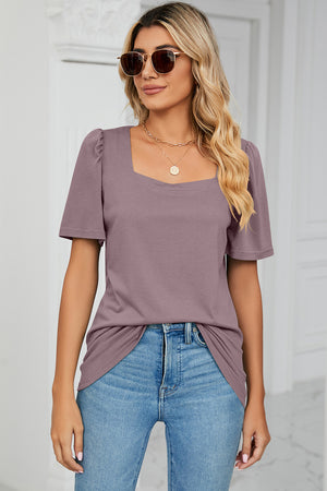 Lilac tee with square neckline and puffed short sleeves.