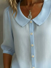 Light blue button-down shirt with Peter Pan collar and puff sleeves.