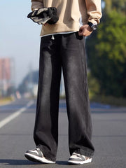 Black relaxed fit 100 cotton jeans with a drawstring waist.