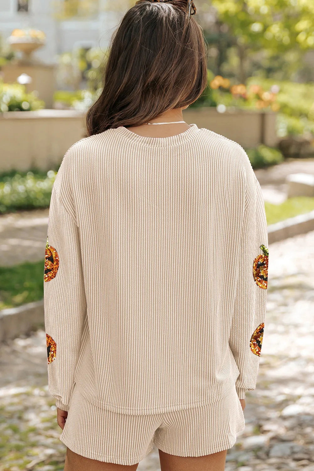 Tan striped loungewear set with sequin pumpkin detail on sleeves.