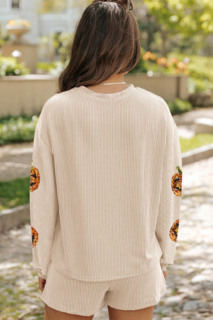 Tan striped loungewear set with sequin pumpkin detail on sleeves.