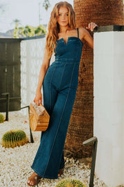 Denim bustier jumpsuit with V-neck and flare legs in dark wash.