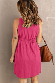 Pink button-down mini dress with gathered waistline and sleeveless design