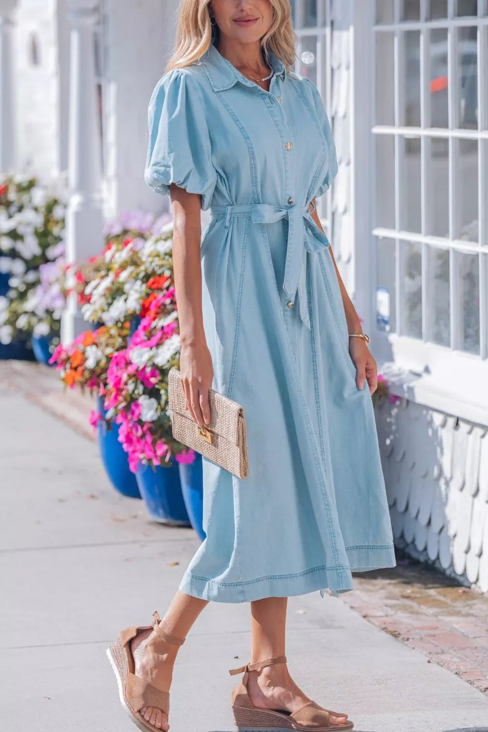 Light blue denim midi dress with puff sleeves, collar, button front, and tie belt.