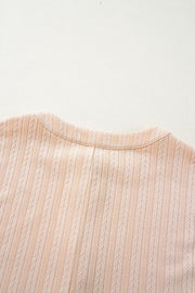 Textured ribbed sleeveless collar jumpsuit in eggshell with a button detail.