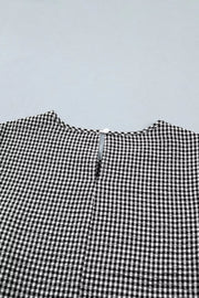 Gingham shirt with ruffled sleeves and bow tie neck detail.
