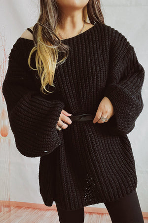 Black oversized ribbed knit mini dress with a belt and boat neckline.