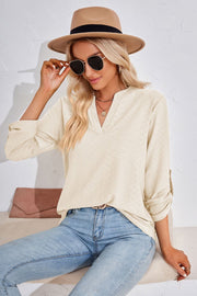 Ivory textured henley blouse with rolled sleeves and a split neckline.