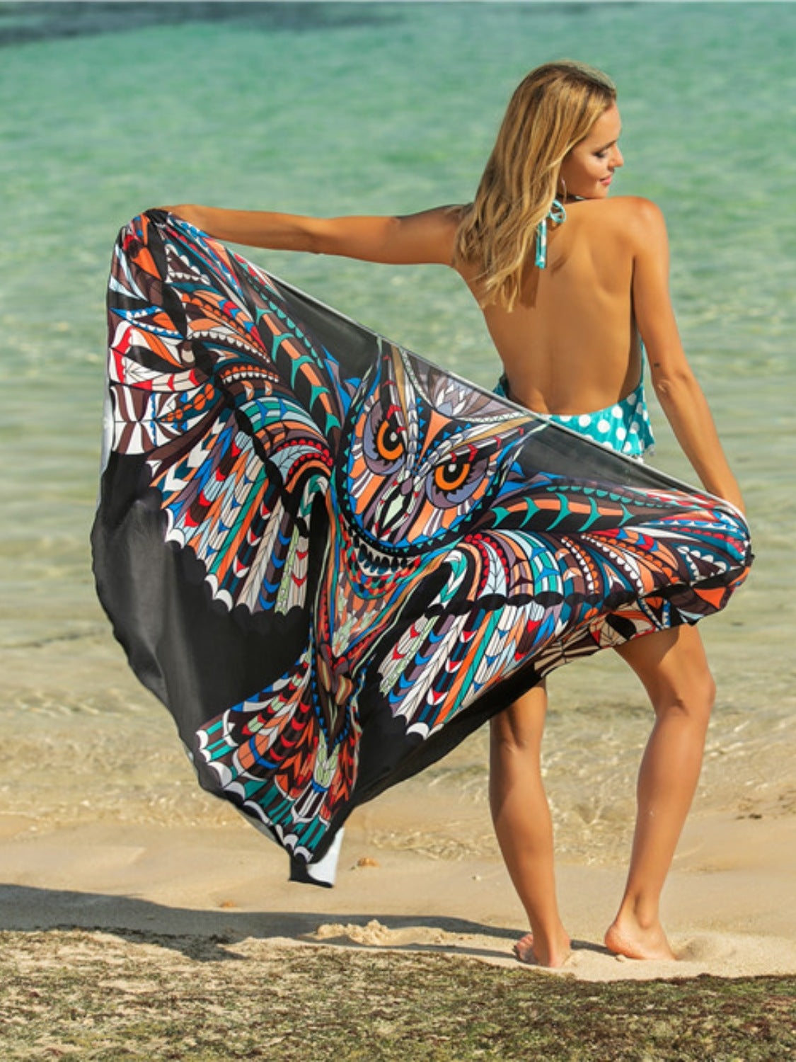 Pareo wrap with a black background and a colorful owl graphic print.