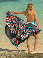 Pareo wrap with a black background and a colorful owl graphic print.