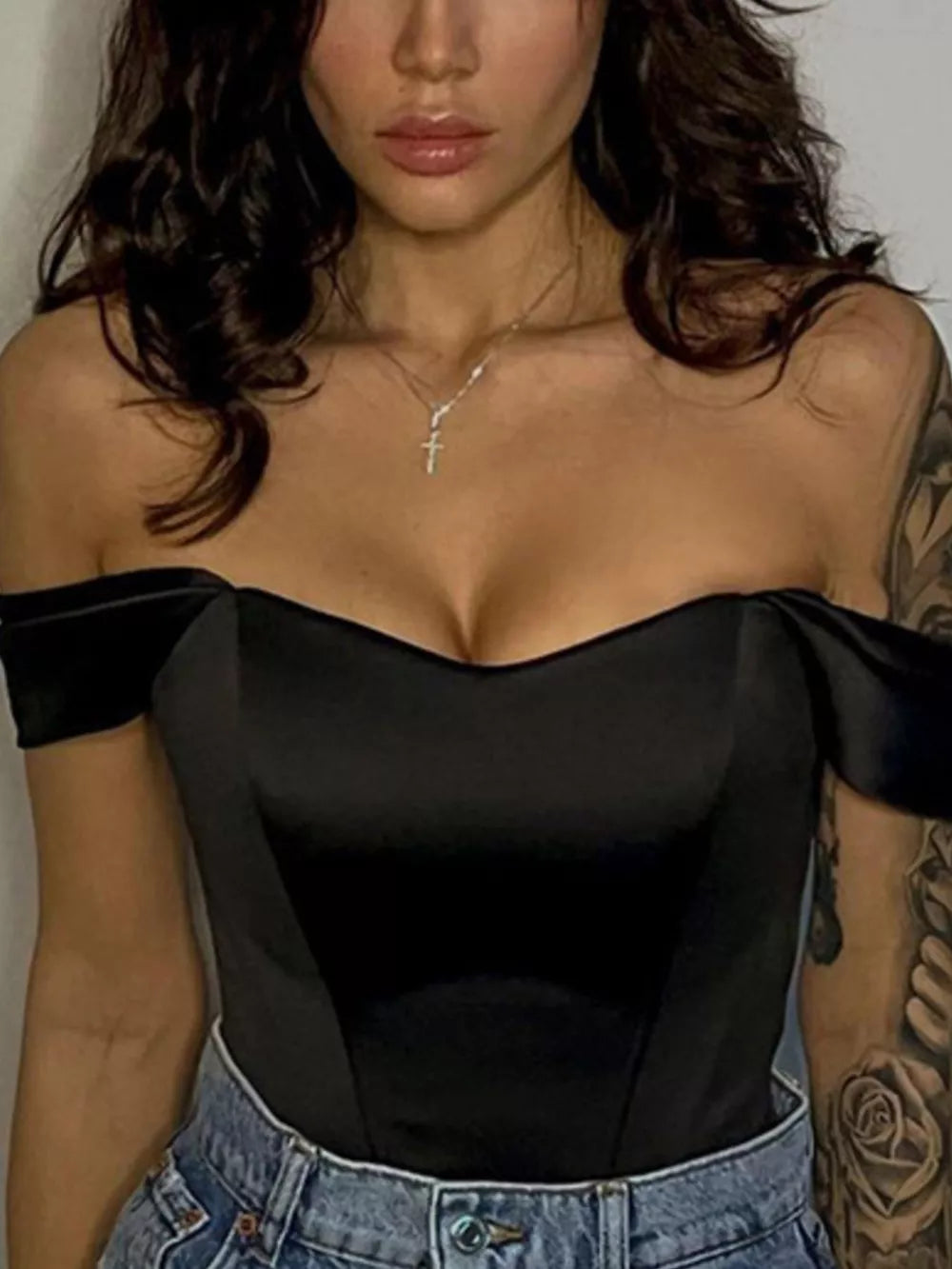 Black sweetheart neckline off-shoulder satin blouse with corset detail and bow sleeves.