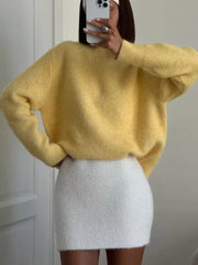 Cozy pastel yellow knit sweater with relaxed fit and crew neck.