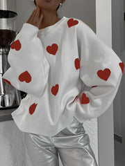 White oversized knit crewneck sweater with red hearts and drop sleeves