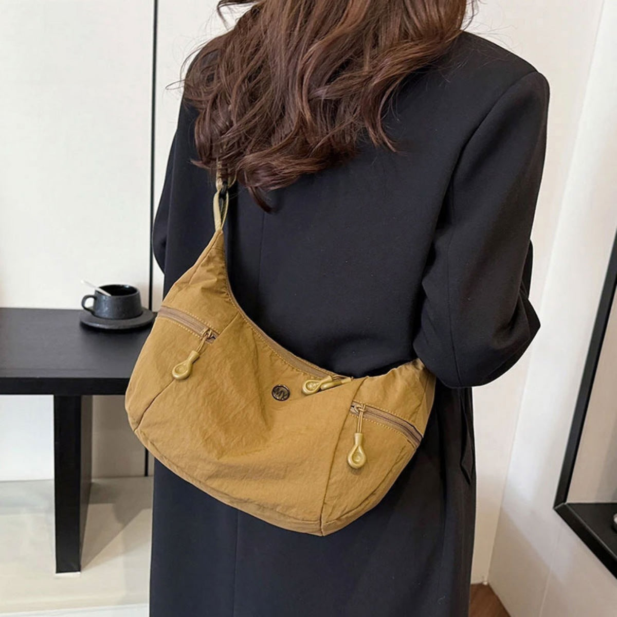 Medium nylon crossbody bag in brown with adjustable strap and zip pockets