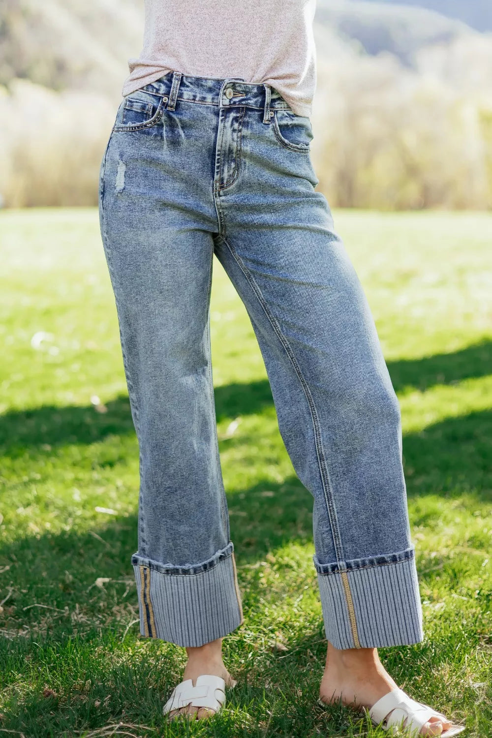 Cuffed mid-rise relaxed fit denim jeans with distressed details and striped cuffs.