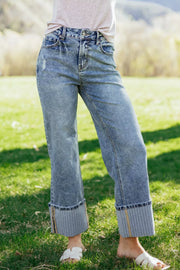 Cuffed mid-rise relaxed fit denim jeans with distressed details and striped cuffs.