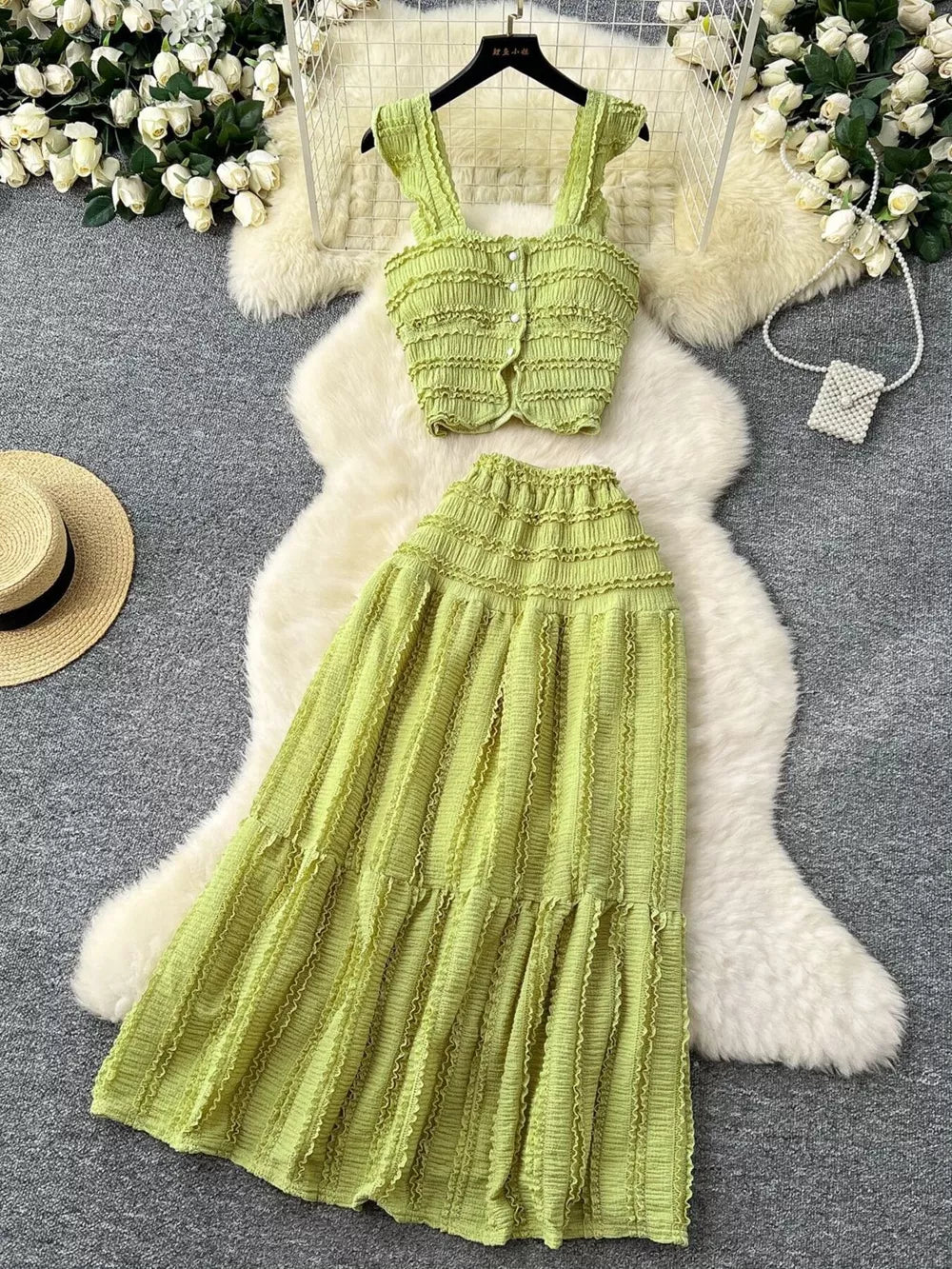Light green textured two-piece set with ruffled details, buttoned crop top and tiered maxi skirt.