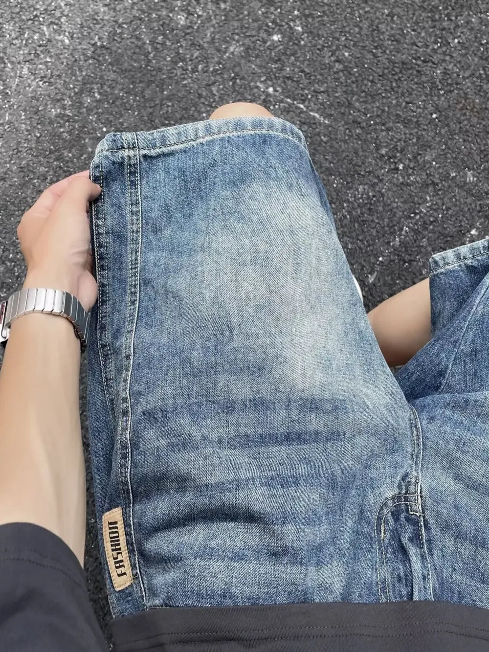 Men's relaxed fit blue denim shorts with a vintage wash and a "Fashion" tab detail.