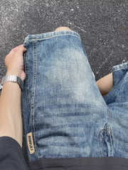 Men's relaxed fit blue denim shorts with a vintage wash and a "Fashion" tab detail.