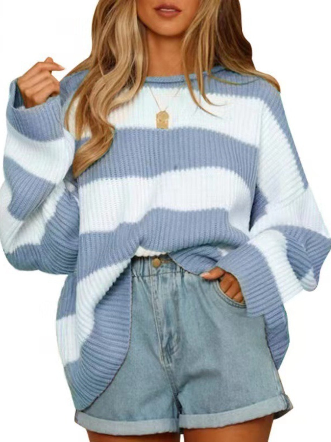Blue and white striped oversized knit sweater with crew neck and wide sleeves.