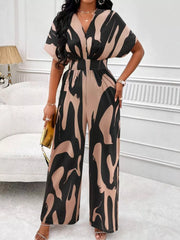 Chic abstract print wide-leg romper in black and khaki with V-neck and short sleeves.