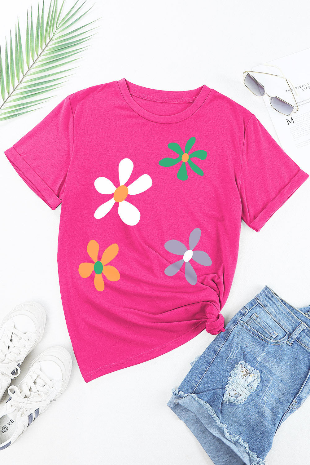 Hot pink t-shirt with a daisy graphic print, short sleeves, and a crew neck.