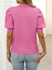 Pink knit sweater with mock neck and puff short sleeves.