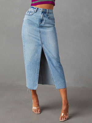 Light wash denim midi skirt with a raw-edge hem and front slit.