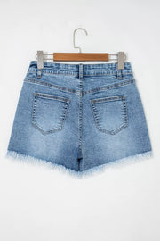 Blue denim shorts with distressed details and frayed hem