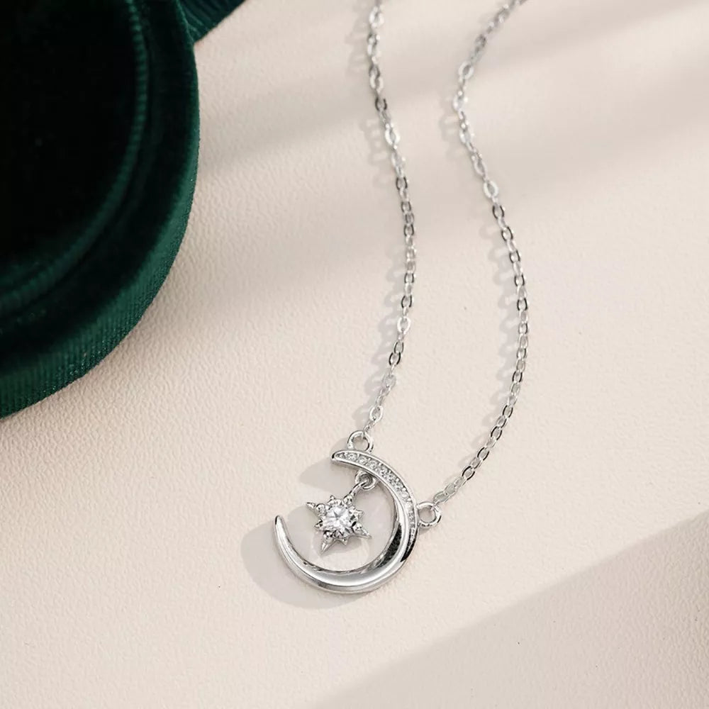 Celestial Moissanite Crescent Necklace with a sparkling star charm.