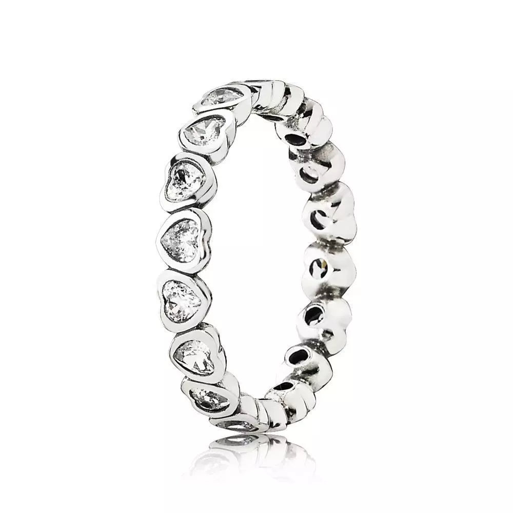 Sterling silver ring with a band of small, clear heart-shaped stones and textured heart details.