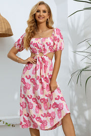 Pink floral midi dress with puff sleeves, square neckline, and cutout waist detail.