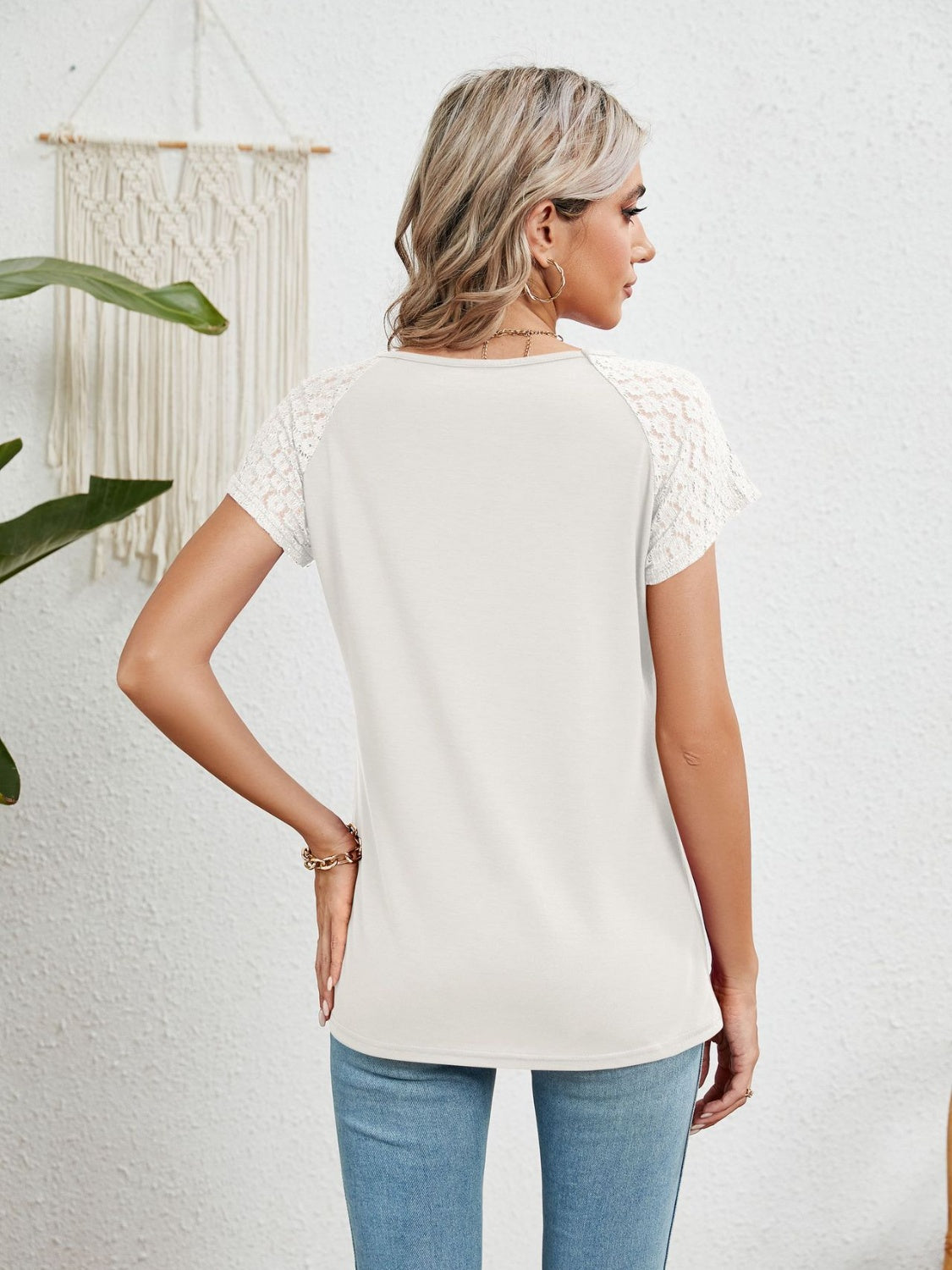 White polyester blouse with lace short sleeves and a round neckline