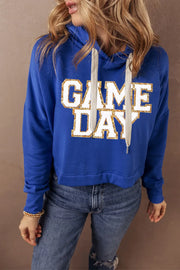 Royal blue cropped hoodie with glitter "GAME DAY" graphic and adjustable drawstring hood.