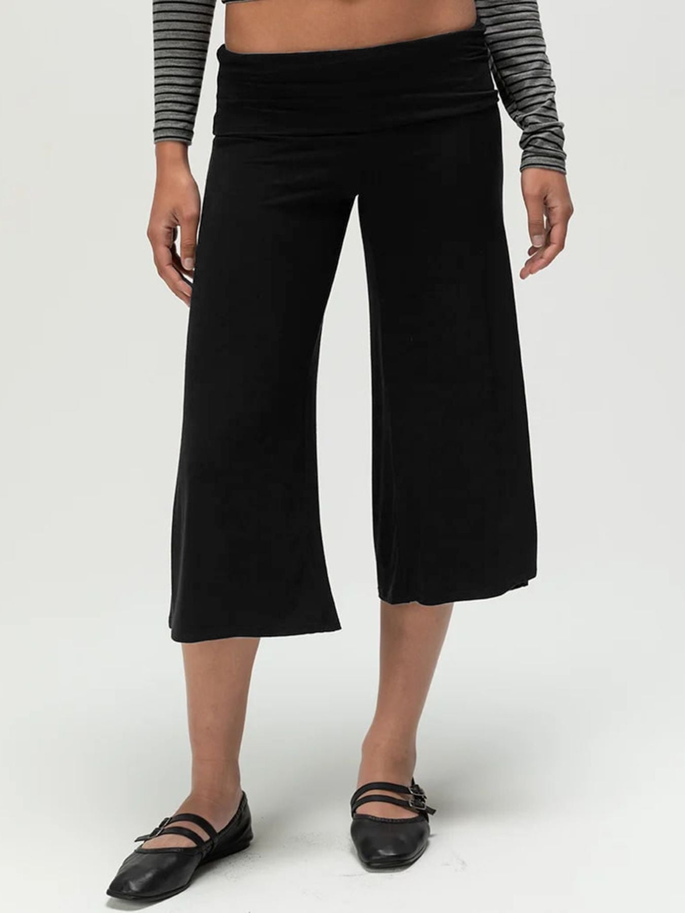 Black relaxed wide leg capris with a foldover waistband and a cropped length.