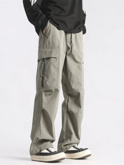 Plus-size loose fit cargo pants in green with drawstring waist and zippered pockets.