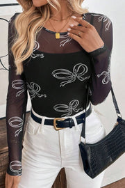 Black mesh bodysuit with white bow print, long sleeves, and a square neckline.