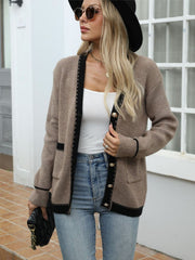 Taupe knit cardigan with black contrast trim and gold buttons.