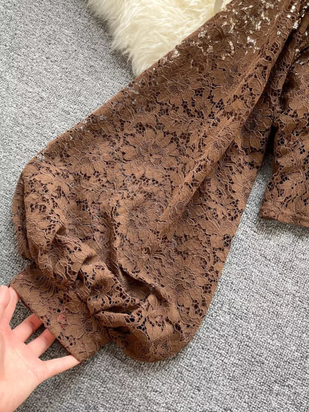 Brown floral lace shirt with balloon sleeves and tie-back detail.