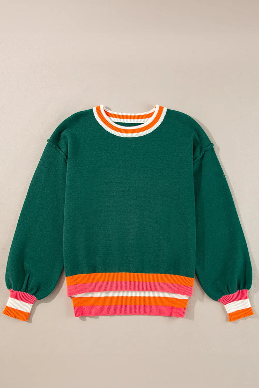 Dark green knit sweater with balloon sleeves and colorblock trim at neckline and hem.