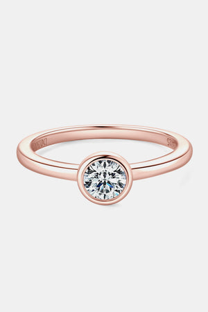 Rose gold solitaire bezel ring with a round-cut diamond.