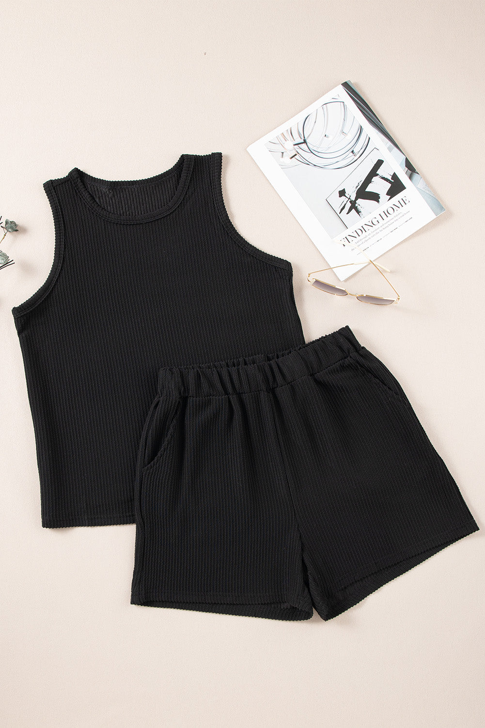 Black ribbed tank top and shorts set with elastic waist and pockets.